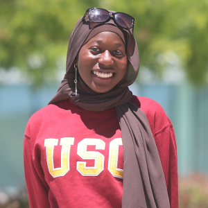 Fatoumata Cisse head shot wearing USC sweatshirt and brown scarf