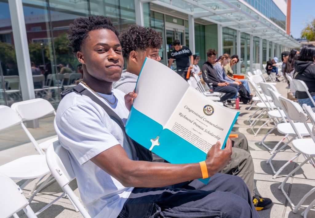 A student shows off a Congressional commendation during the RP Scholar Celebration on August 3, 2024.