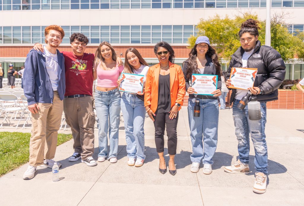 Six students pose with RP Board Chair Nicole Barnett, two holding certificates, during the RP Scholar Celebration on August 3, 2024.
