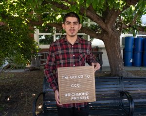 A new Richmond Promise Scholar holds a sign that says "I'm Going to CCC - #RichmondPromise" at RP's 2025 Scholar Celebration.