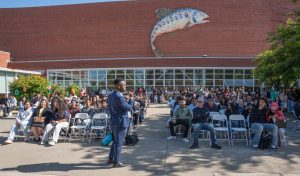 RP Executive Director Christopher Whitmore addresses the crowd in the Richmond Art Center courtyard at the 2025 Scholar Celebration
