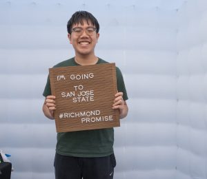 A new Richmond Promise Scholar holds a sign that says "I'm Going to San Jose State - #RichmondPromise" at RP's 2025 Scholar Celebration.