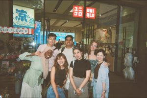 Fatoumata Cissé poses for a photo with fellow cohort members under a Uniqlo sign during her week in Japan.