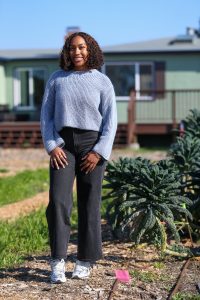 Bailey Ward poses for a photo on the farm at Urban Tilth