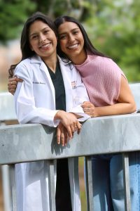 Adriana and Celina Mendoza hug while posing for a photo at Contra Costa College